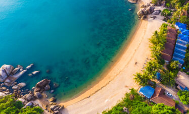 Aerial view of beautiful tropical beach and sea with palm and other tree in koh samui island for travel and vacation